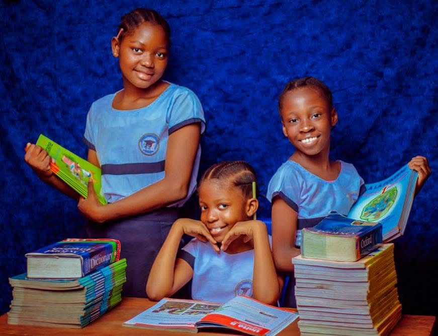 BCP students holding an English dictionary and workbooks