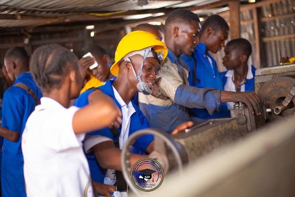 BCP students in a hands-on skills workshop, wearing safety helmets while working with equipment
